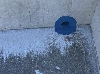 水抜き穴に液状防蟻処理材を施工している様子